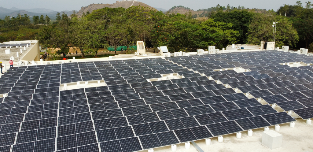 Solar panels on electronics manufacturing facility rooftop" For images showing renewable energy sources or energy-efficient facilities.